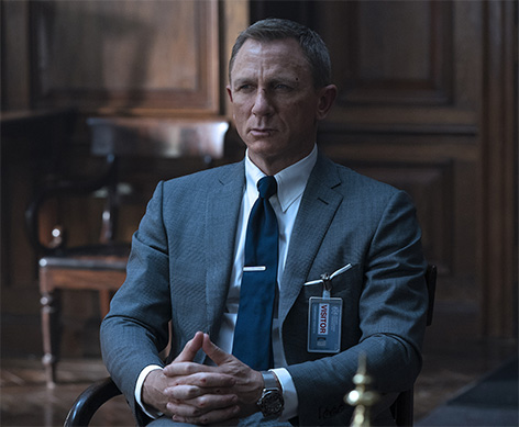 James Bond in TOM FORD Grey Wool Prince of Wales Check O’Connor Notch Lapel Jacket, O’Connor Tailored Trousers, Sea Island Poplin Collared Shirt and Off White Silk Pocket Square