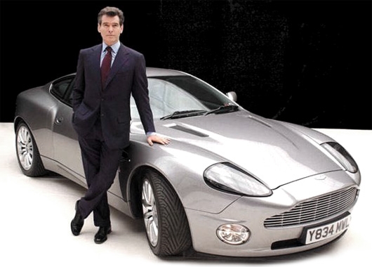 Pierce Brosnan posing with an Aston Martin Vanquish