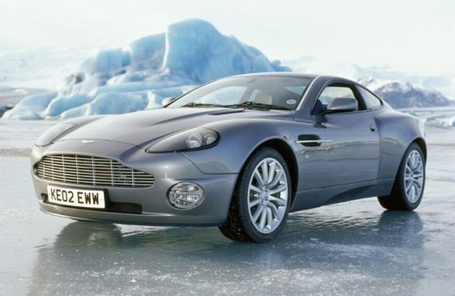 Pierce Brosnan posing with an Aston Martin Vanquish