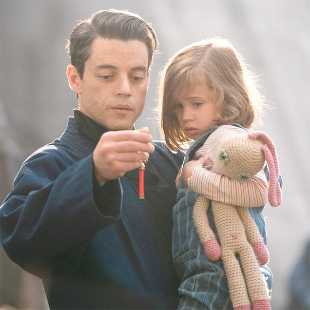 photo © Danjaq LLC, MGM, United Artists Safin carries Mathilde and her Dou Dou in No Time To Die.