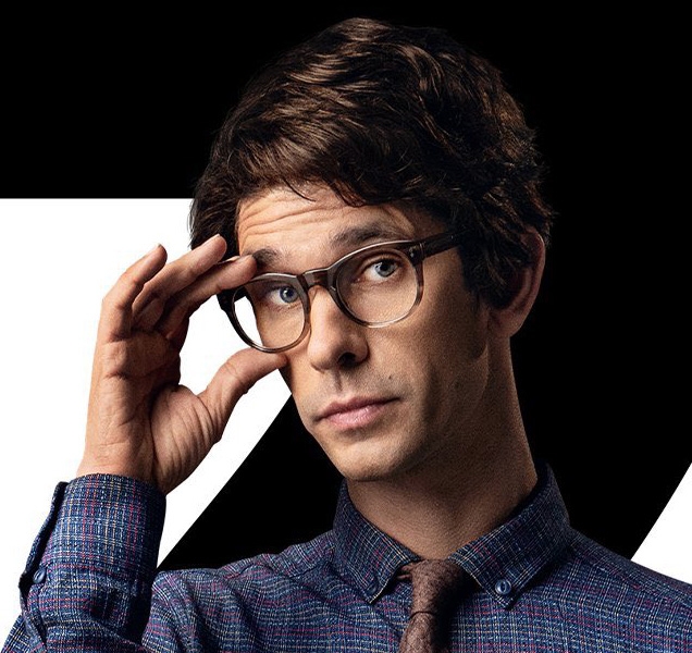 Q (Ben Whishaw) wears Moscot Mensch eyeglasses on this character poster for No Time To Die