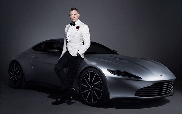 Daniel Craig as James Bond poses with the Aston Martin DB10
