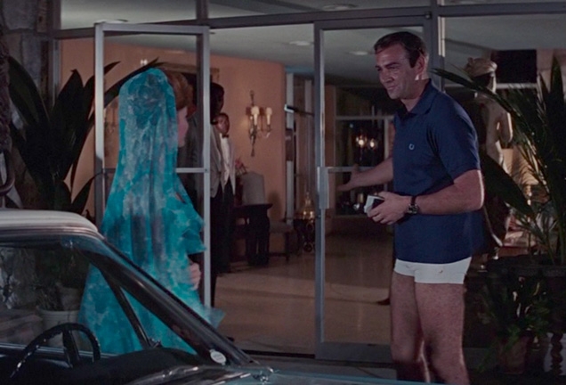 James Bond wears a navy Fred Perry polo shirt and white Jantzen shorts in Thunderball.