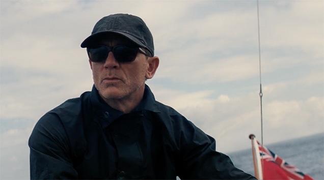 Daniel Craig as James Bond wears a Carhartt cap in the movie No Time To Die.