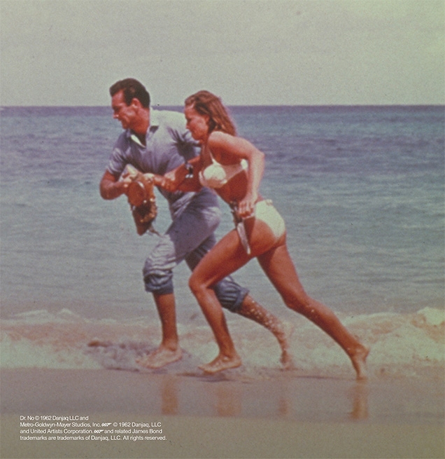 Sean Connery as James Bond and Ursula Andress as Honey Ryder running on the Jamaican beach in Dr. No