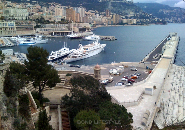 The theatre is visible in the left front of the image and the the harbor of Monaco behind it