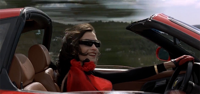 Xenia Onatopp (Famke Janssen) wears Versace shield sunglasses in GoldenEye.