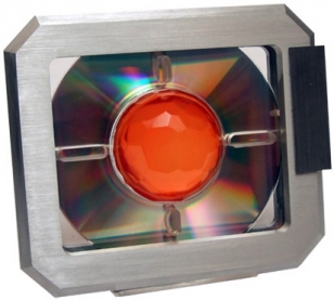 Brushed aluminium frame. The center part contains an actual cd-rom, in an acrylic setting, the Central lens is cast ‘amber’ polycarbonate.
